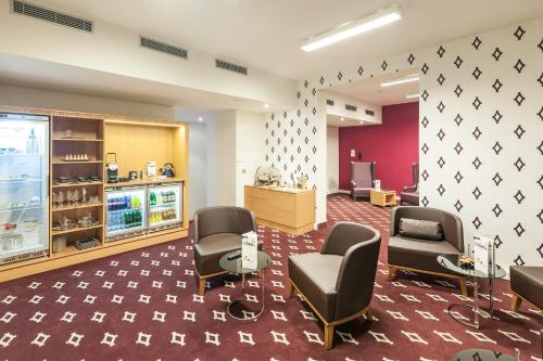 a waiting room with chairs and a hair salon at Mercure Ostrava Center in Ostrava