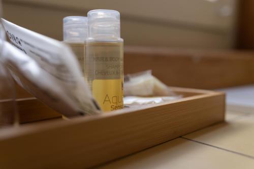 a wooden box with a bottle of oil in it at Boutique-Hotel Stadtherberge Wetzlar in Wetzlar