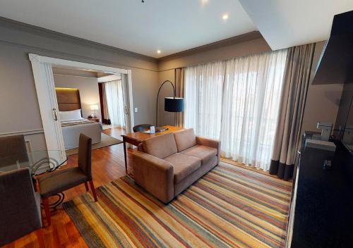 a hotel room with a couch and a bed at Gran Estanplaza Berrini in Sao Paulo