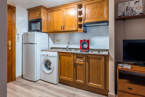 a kitchen with a white refrigerator and a washer at Santa Cruz in Broto