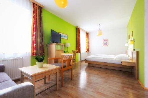 a living room with a bed and a couch at Belvedere in Semmering