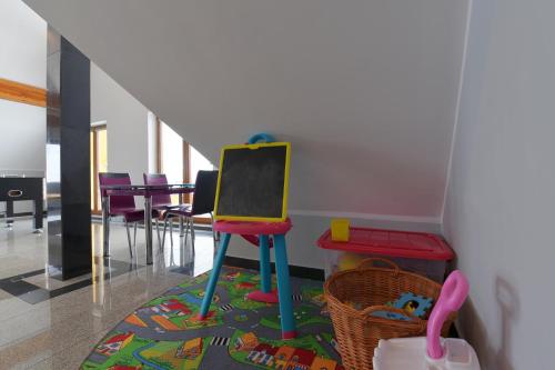 a classroom with a chalkboard and a table and chairs at Dom Wczasowy Na Szczycie in Zakopane