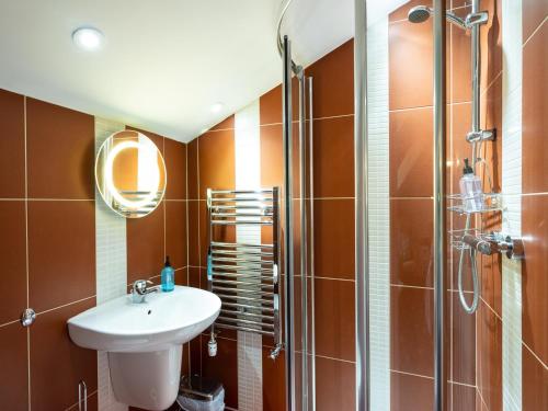 a bathroom with a sink and a shower at Old Posting House in Cockermouth