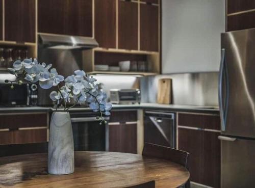 a vase with flowers on a table in a kitchen at Bishop Arts Hotel in Dallas