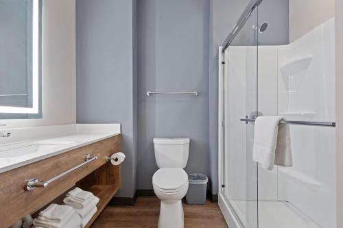 a bathroom with a toilet and a sink and a shower at Extended Stay America Premier Suites - Daytona Beach - Ormond Beach in Ormond Beach