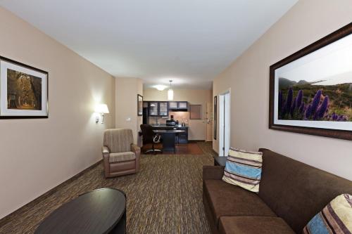 a living room with a couch and a desk at Candlewood Amarillo-Western Crossing by IHG in Amarillo