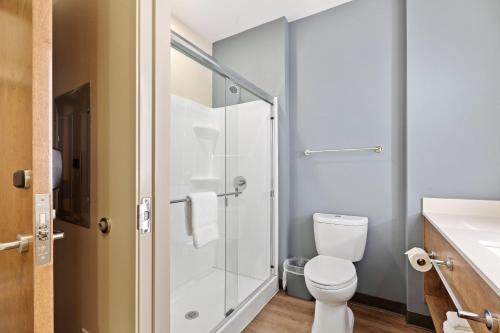 a bathroom with a toilet and a glass shower at Extended Stay America Premier Suites - Daytona Beach - Ormond Beach in Ormond Beach