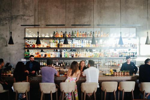 a group of people sitting at a bar at Kimpton Everly Hotel Hollywood by IHG in Los Angeles