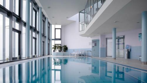 an empty swimming pool in a building with windows at InterContinental Warszawa by IHG in Warsaw