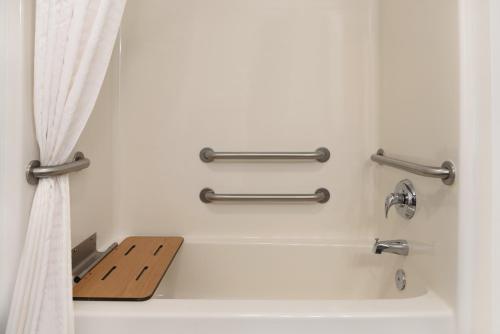 a bathroom with a bath tub with a shower curtain at Country Inn & Suites by Radisson, Galena, IL in Galena