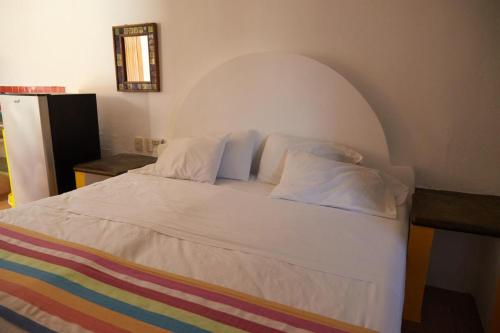 a bedroom with a white bed with an arched ceiling at Pargos Hotel & Cowork in Puerto Escondido
