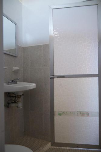 a bathroom with a shower and a sink at Pargos Hotel & Cowork in Puerto Escondido