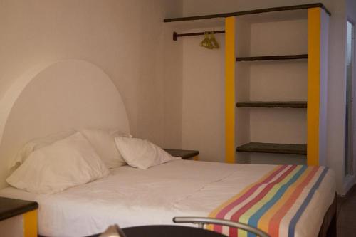 a bedroom with a bed with a white bedspread at Pargos Hotel & Cowork in Puerto Escondido