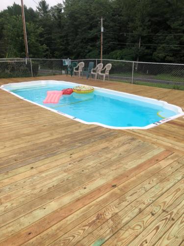 una piscina con un frisbee en la parte superior de un suelo de madera en The HideAway Tiny Cabin en East Durham