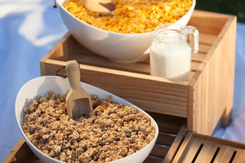 a tray with two bowls of food and a container of milk at Holiday Inn Express - Birmingham - City Centre by IHG in Birmingham