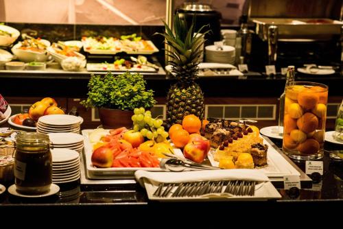 a buffet with many plates of food on a table at Holiday Inn Łódź by IHG in Łódź