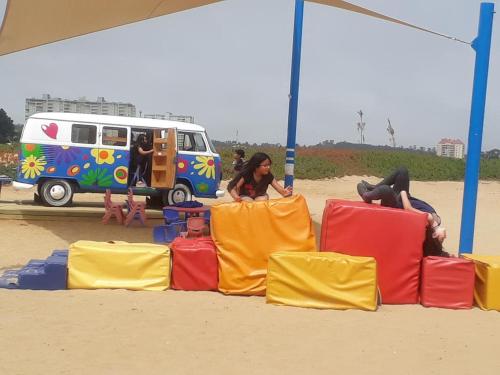 a group of people sitting on chairs on the beach at DEPTO LAGUNA BAHIA MARINA in Algarrobo