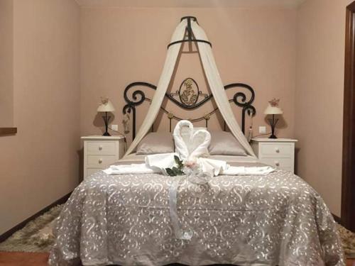 a bedroom with a large bed with a flower on it at La Riguera De Ucieda in Ucieda de Arriba