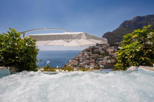 a white umbrella and a view of a city at Villa Fiorentino in Positano