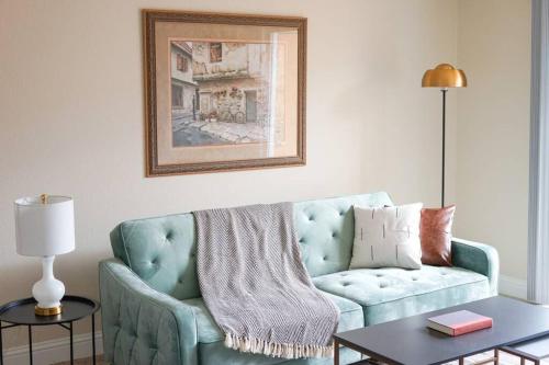 a living room with a blue couch and a table at Sleepover 1BD 1BA Oklahoma City Apartments in Oklahoma City