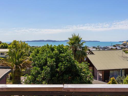 a view of the ocean from a house at Kawau Vista - Snells Beach Holiday Home in Snells Beach