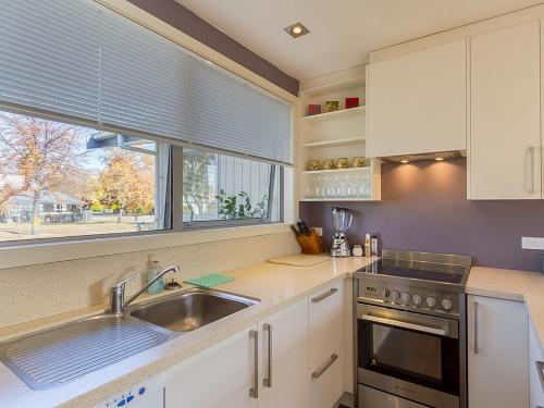 a kitchen with a sink and a window at Brow Peak View - Arrowtown Holiday Home in Arrowtown