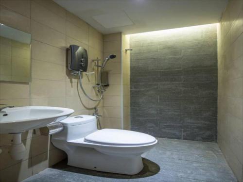 a bathroom with a toilet and a sink and a shower at Sovotel @ Kelana Jaya 73 in Petaling Jaya