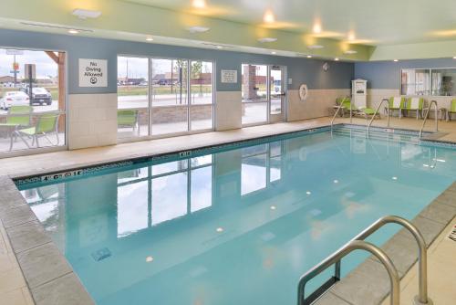 a large swimming pool with blue water in a building at Holiday Inn Express & Suites - Ogallala by IHG in Ogallala