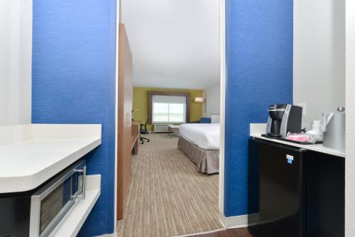 a hotel room with a bed and a bathroom at Holiday Inn Express & Suites - Ogallala by IHG in Ogallala