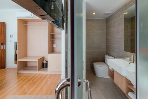 a bathroom with a sink and a toilet at The Empire Hotel in Phu Quoc