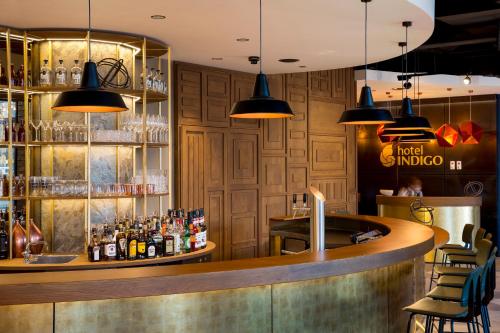 a bar at a restaurant with lights at Hotel Indigo Dresden - Wettiner Platz by IHG in Dresden