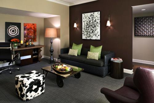a living room with a couch and a table at Kimpton Hotel Vintage Seattle by IHG in Seattle