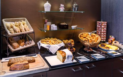 a buffet with various types of bread and pastries at Holiday Inn Toulouse Airport by IHG in Blagnac