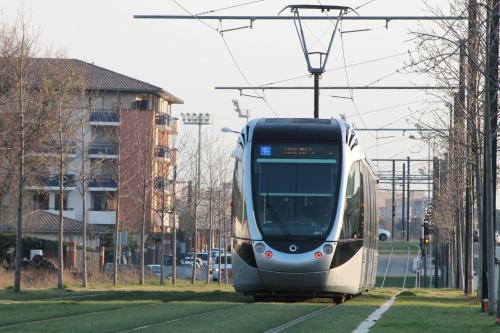 a tram is on the tracks in a city at Holiday Inn Toulouse Airport by IHG in Blagnac