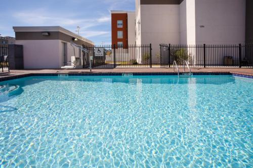 a large pool with blue water in front of a building at Holiday Inn Express Slidell by IHG in Slidell