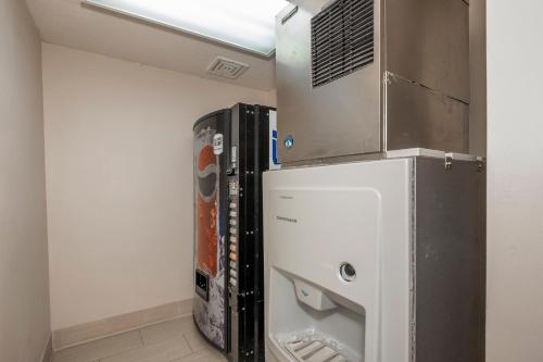 a room with a refrigerator with a stack of servers at Red Roof Inn & Suites Corbin in Corbin