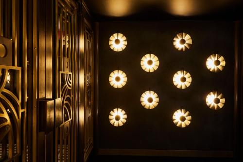 a wall with a bunch of lights on it at Hotel Indigo London - 1 Leicester Square by IHG in London