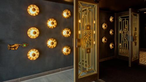 a room with a wall with many circular objects on the wall at Hotel Indigo London - 1 Leicester Square by IHG in London