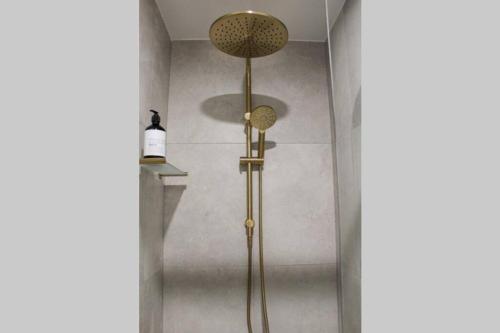 a shower with two lights in a bathroom at Coombs Hill Barn in Merrijig