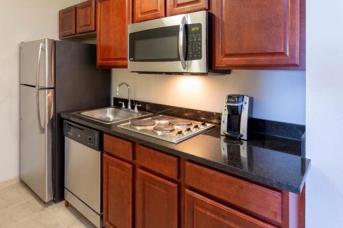 a kitchen with a sink and a microwave at Holiday Inn Express Hotel & Suites-St. Paul by IHG in Vadnais Heights