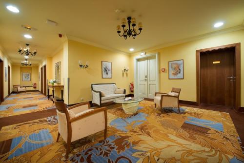 a lobby with chairs and a couch and a table at Grandhotel Zvon in České Budějovice