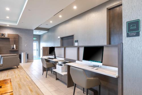 an office with a desk with a computer on it at Holiday Inn Greenville - Woodruff Road by IHG in Greenville