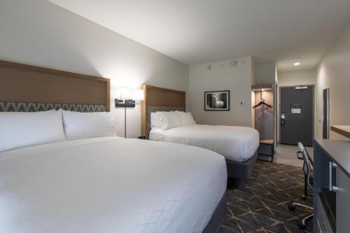 a hotel room with two beds and a kitchen at Holiday Inn Greenville - Woodruff Road by IHG in Greenville