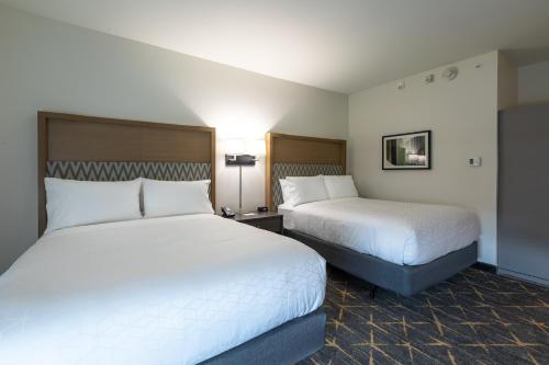 two beds in a hotel room with two beds at Holiday Inn Greenville - Woodruff Road by IHG in Greenville