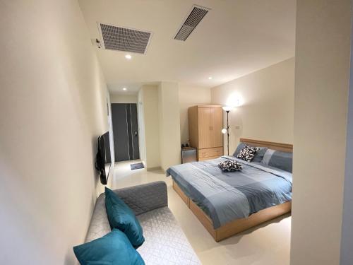 a bedroom with a bed and a couch at Candy House in Zhushan