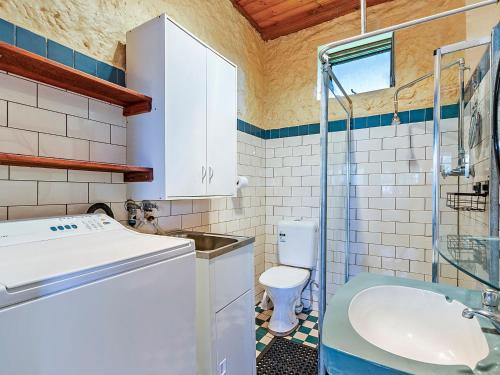 a bathroom with a sink and a toilet at The Stables in Port Fairy