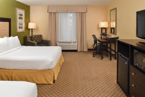 a hotel room with a bed and a desk at Holiday Inn Express Woodland by IHG in Woodland