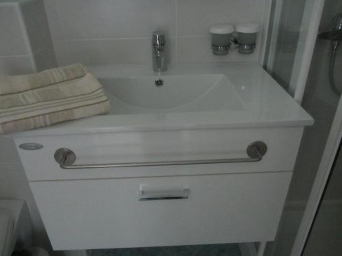 a white sink with a faucet and a towel at Villa Tollazzi in Logatec