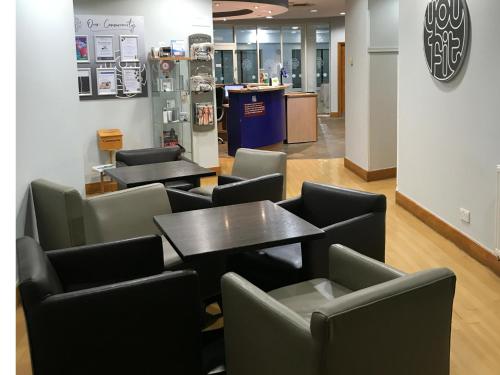 a restaurant with tables and chairs in a room at Holiday Inn Taunton M5, Jct25 by IHG in Taunton