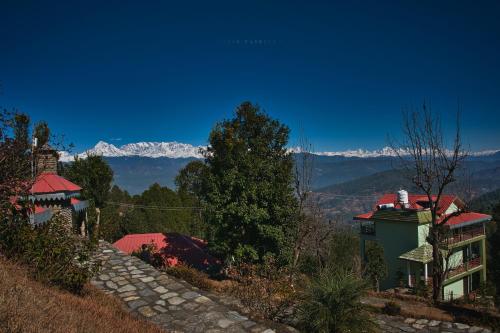 a view of the mountains from a house at Himalaya Darshan Resort in Kausani